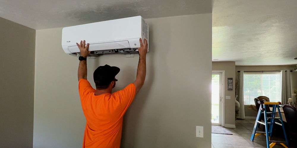 HVAC equipment cost comparison ACiQ vs big HVAC brands showing technician installing mini split system indoors