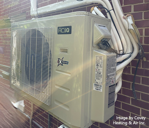 ACiQ Extreme mini split outdoor unit installed on a brick building.