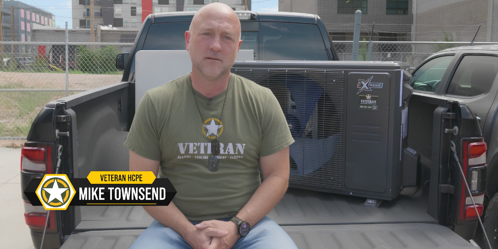 Mike Townsend of Veteran Heating, Cooling, Plumbing, & Electric beside an ACiQ Extreme HVAC unit