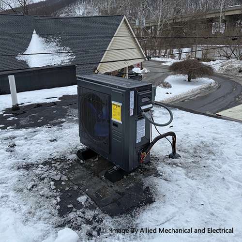 ACiQ mini split outdoor unit installed on a snow-covered rooftop in Central Pennsylvania