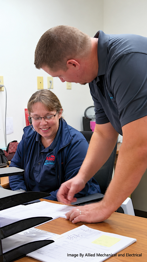 Allied Mechanical & Electrical office staff working together on customer service scheduling