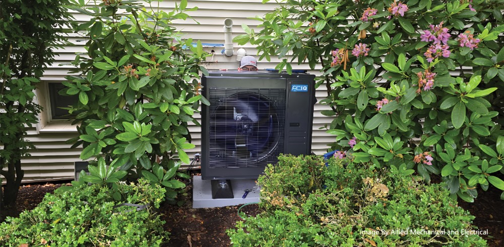 ACiQ heat pump outdoor unit installed beside a home by Allied Mechanical & Electrical